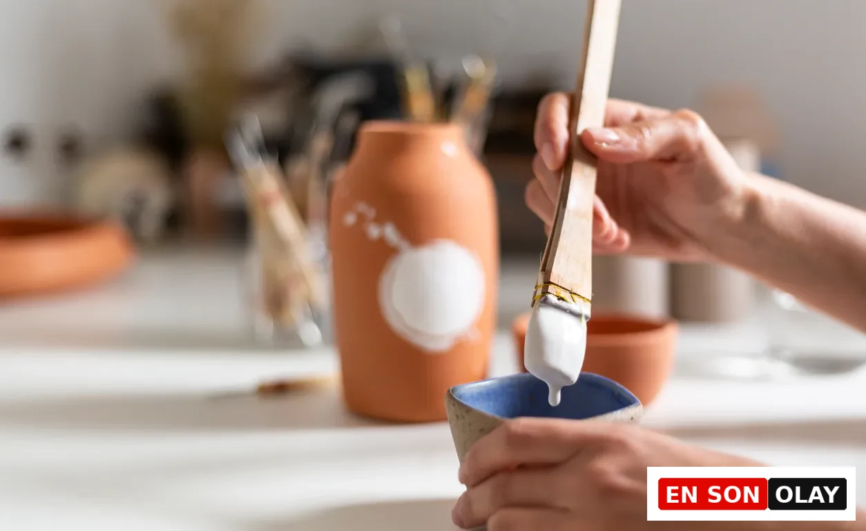 Ev ortamında seramik boyasıyla çalışan bir kişinin elleri, analog ve sessiz bir hobi anı