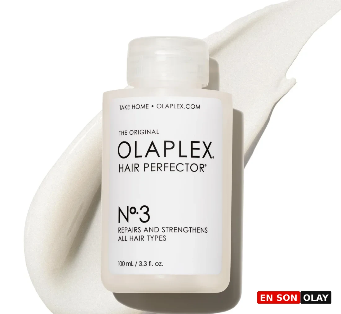 Beyaz renkli, siyah kapaklı Olaplex No. 3 Hair Perfector şişesi, yıpranmış ve hasarlı saçların bağlarını onarmaya yardımcı olan, saçları güçlendiren ve pürüzsüzleştiren etkili bir evde saç bakımı ürünü olarak sade bir arka plan üzerinde dikkat çekici bir şekilde konumlandırılmış.